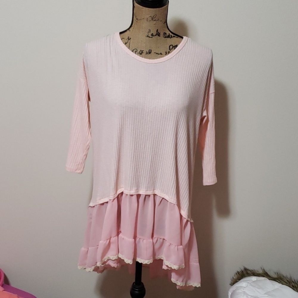 Large baby pink top with ruffel bottom.